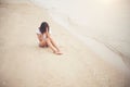 Young woman with looks lonely feel sit on the beach. Sad woman a