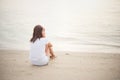 Young woman with looks lonely feel sit on the beach. Sad woman a