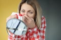 Young woman looks in mirror and bleeds from nose Royalty Free Stock Photo