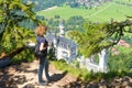 Young woman looks at Neuschwanstein castle, Bavaria, Germany Royalty Free Stock Photo