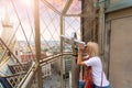 A young woman looks through observation binoculars and enjoys the panorama of the city in Vienna, Austria Royalty Free Stock Photo