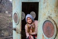 Young woman looks out of the vintage cable car cabin