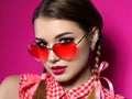 Young Woman Looks Over Heart Shaped Glasses