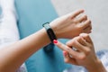 Young woman looks at a sports watch, checking performance or heart rate. Sports and fitness at home Royalty Free Stock Photo