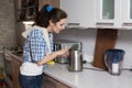 Woman looks at the teapot if there is an inscription Royalty Free Stock Photo