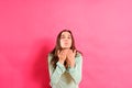 Young woman with loving attitude blows kisses with her hand looking for a partner during her single life,  on pink Royalty Free Stock Photo