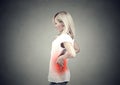 Young woman with lower back pain colored in red Royalty Free Stock Photo