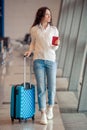 Young woman with luggage in international airport. Airline passenger in an airport lounge waiting for flight aircraft Royalty Free Stock Photo