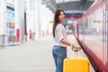 Young woman with luggage on train platform waiting Royalty Free Stock Photo