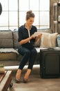 Young woman with luggage using tablet pc