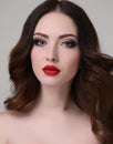 Young woman with luxurious dark hair and evening makeup