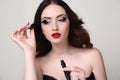 Young woman with luxurious dark hair and evening makeup