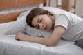 Young woman lying alone in her bed, mourning about loss of loved one, suffering from severe depression Royalty Free Stock Photo