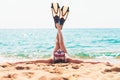 Young woman lying on the beach stretching up slender legs wearing diving mask Royalty Free Stock Photo