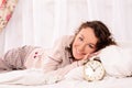 Young woman lying on bed and alarm clock Royalty Free Stock Photo