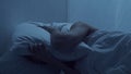 Young woman lying in the bed at night and having insomnia disease. Beautiful blond sleeping girl. Twilight in the Royalty Free Stock Photo