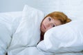 Young woman lying in bed sick unable to sleep suffering depress Royalty Free Stock Photo