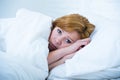 Young woman lying in bed sick unable to sleep suffering depression and nightmares insomnia sleeping disorder Royalty Free Stock Photo