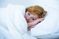 Young woman lying in bed sick unable to sleep suffering depression and nightmares insomnia sleeping disorder