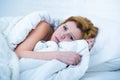 Young woman lying in bed sick unable to sleep suffering depression and nightmares insomnia sleeping disorder Royalty Free Stock Photo