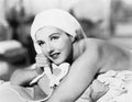 Young woman lying on the bed and talking on the telephone Royalty Free Stock Photo