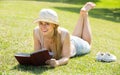 Young woman lying with book outdoors Royalty Free Stock Photo