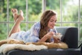 Young woman lying on a couch holding a bowl of yogurt Royalty Free Stock Photo