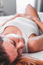 Young woman lying down in pain on the bed Royalty Free Stock Photo