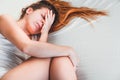 Young woman lying down in pain on the bed Royalty Free Stock Photo