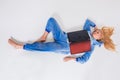 Young woman lying on the floor in his pajamas with a laptop. Royalty Free Stock Photo