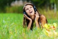 Young woman lying grass headphones Royalty Free Stock Photo