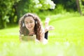 Young woman lying on the grass listening to music Royalty Free Stock Photo