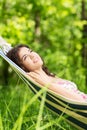 Young woman lying in a hammock