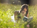 Young woman lying in meadow reading book Royalty Free Stock Photo