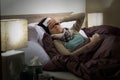 Young woman lying sick in bed cold