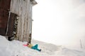 Young woman lying on the snowboard in the mountain resort Royalty Free Stock Photo