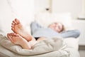 Young woman lying on sofa, focus on her feet Royalty Free Stock Photo