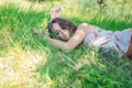 Young woman lying on soft fresh spring grass