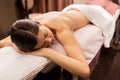 Young woman lying at spa or massage parlor