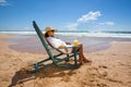 Young woman lying in straw hat in sunglasses on beach Royalty Free Stock Photo