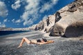 Young woman lying at Vlychada beach in Santorini, Greece Royalty Free Stock Photo