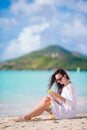 Young woman talking on phone during tropical beach vacation. Beautiful girl on the beach with cellphone on caribbean Royalty Free Stock Photo