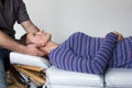 Osteopath treating woman patient`s neck