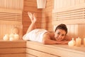 Young woman lying on wooden bench in sauna Royalty Free Stock Photo