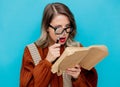 Young woman with magnifier and books