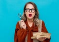 Young woman with magnifier and books