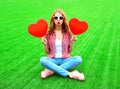 young woman makes an air kiss with red balloon in the shape of a heart Royalty Free Stock Photo