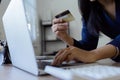 Young woman makes a purchase on the Internet on the laptop with credit card Royalty Free Stock Photo