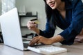 Young woman makes a purchase on the Internet on the laptop with credit card Royalty Free Stock Photo