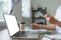 Young woman makes a purchase on the Internet on the laptop with credit card Royalty Free Stock Photo